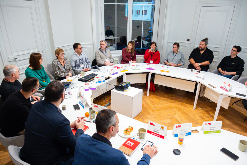 Member of BNI Chapter explaining Structured system to visitor