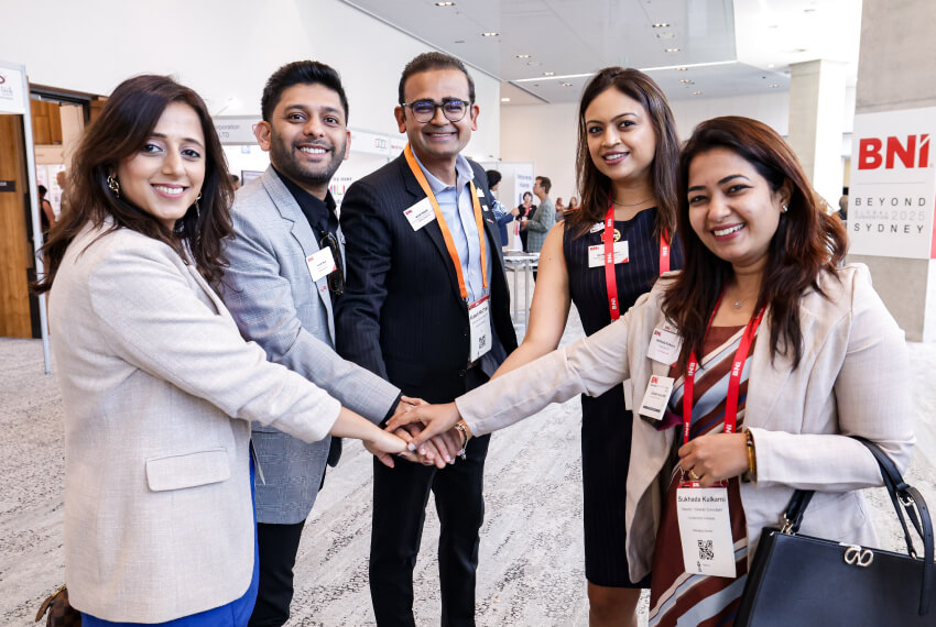 BNI members demonstrating teamwork and collaboration at a business networking conference.