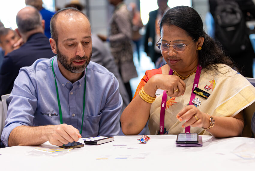 Business professionals connecting to generate business during a networking meeting.